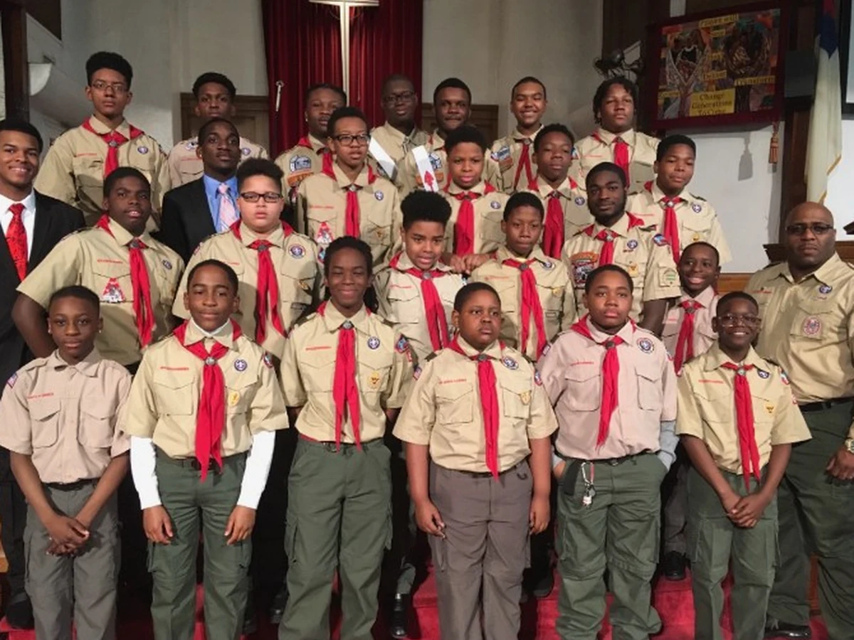 Troop members pose together in uniform.