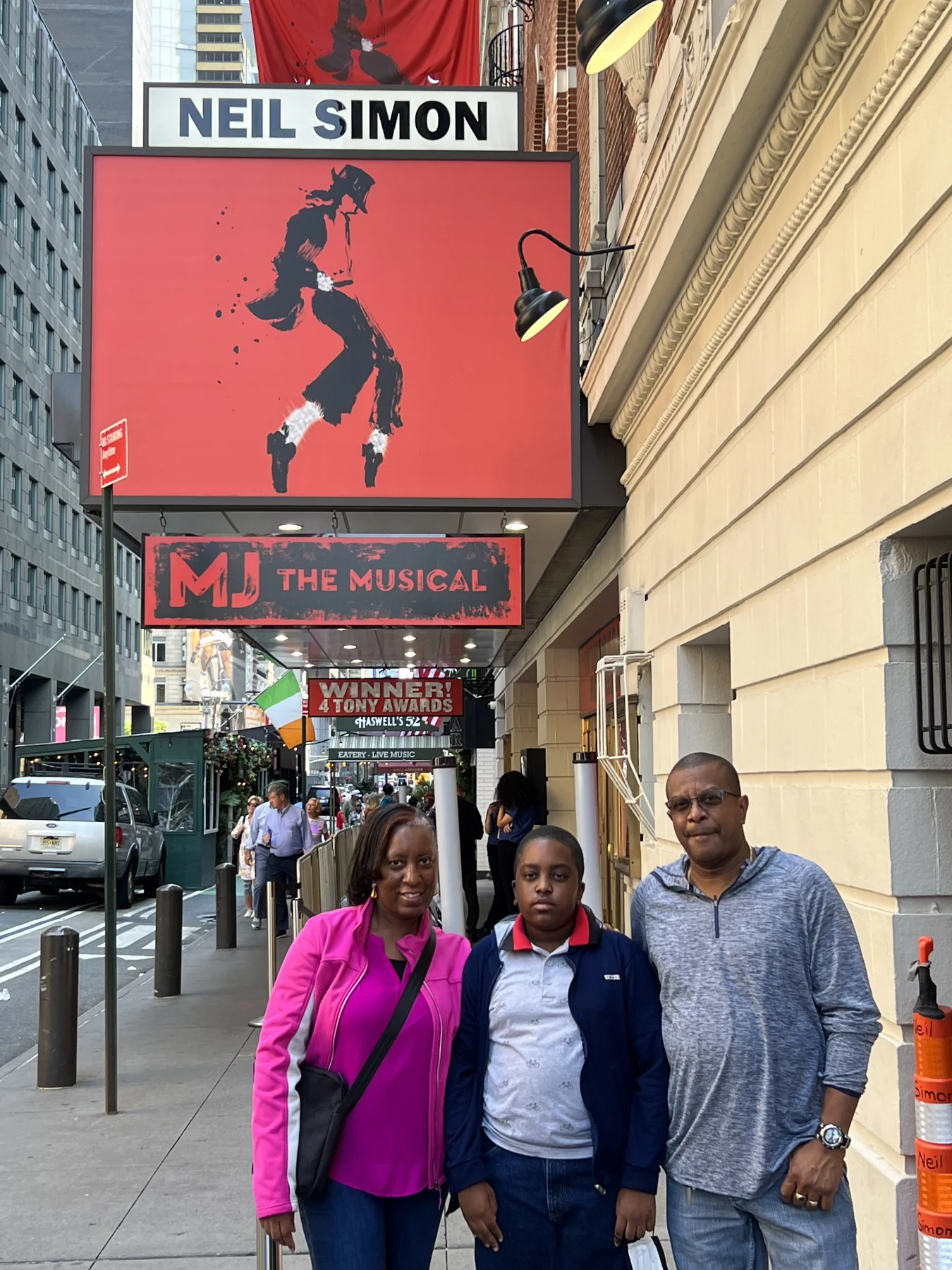 A group poses beneath the MJ The Musical marquee.