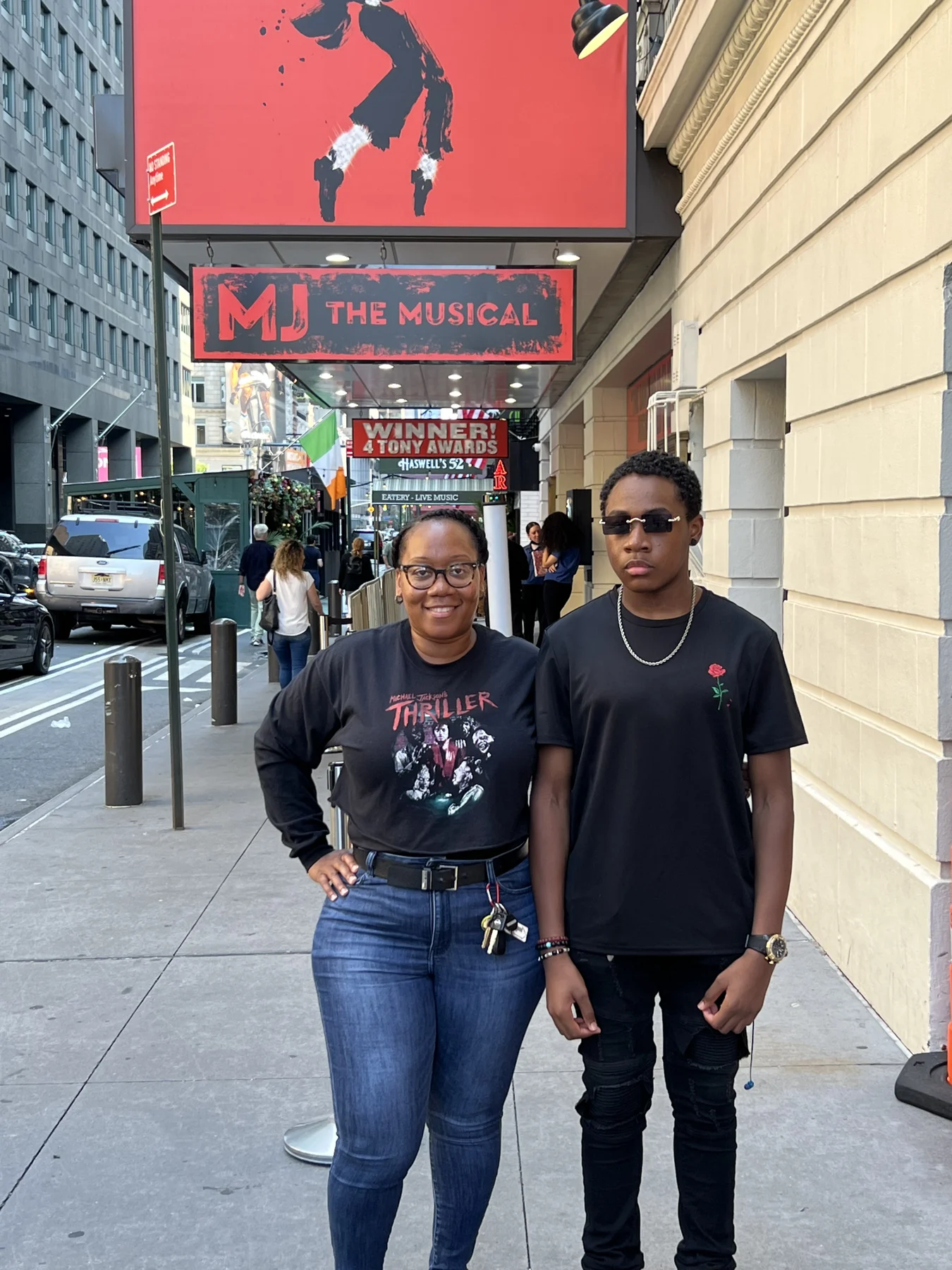 Two members of the outing pose outside the theatre.