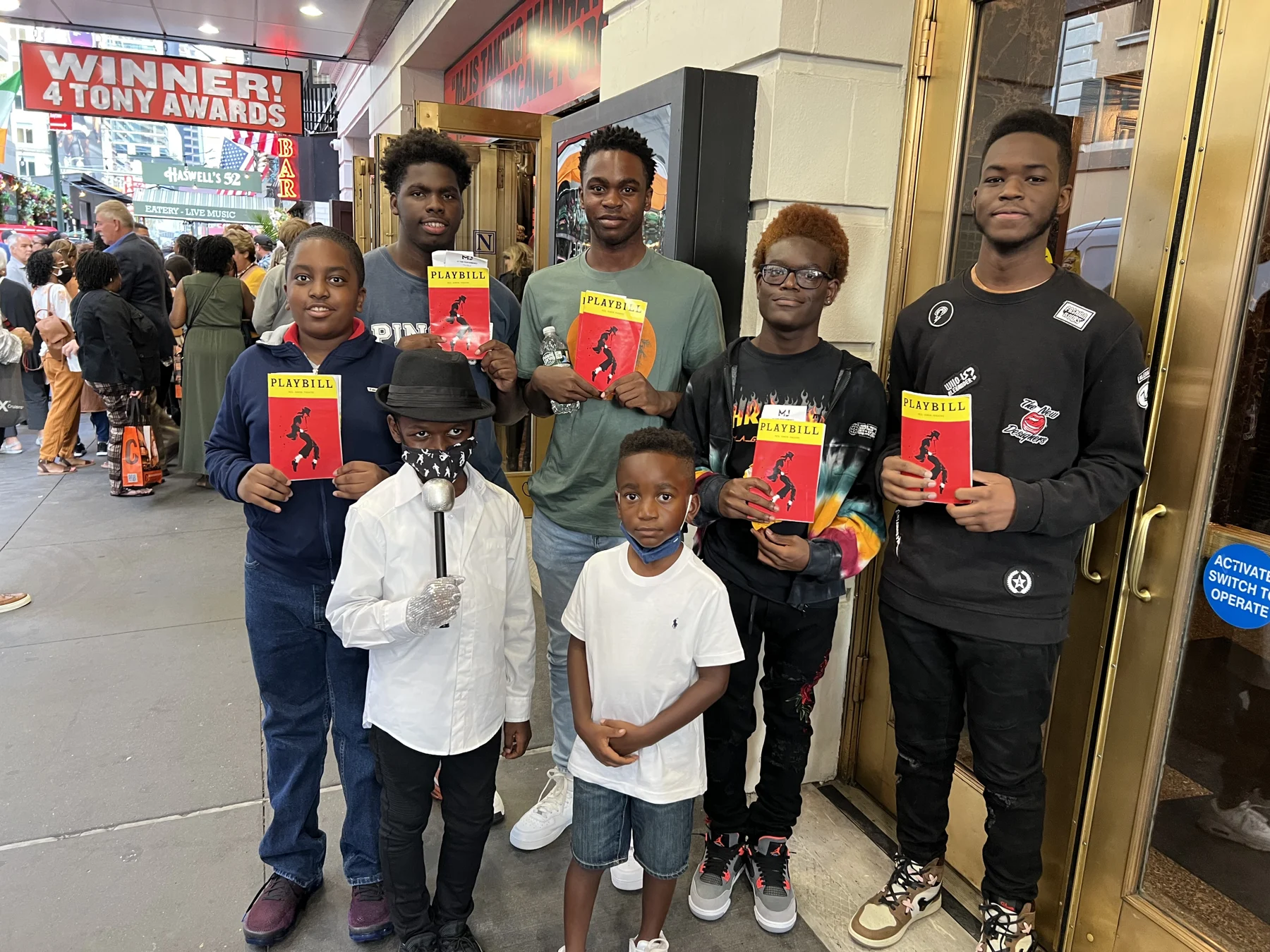 Troop members and families holding MJ theatre programs
