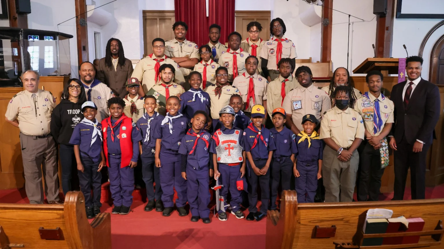 Scouts, Cub Scouts, leaders and families gathered at a ceremony